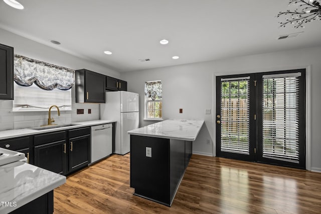 4619 Cross Ridge Ln, Greensboro, NC 27410 - kitchen featuring white appliances, plenty of natural light, tasteful backsplash, recessed lighting, and light stone counters