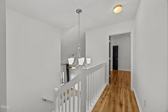 4619 Cross Ridge Ln, Greensboro, NC 27410 - corridor featuring an upstairs landing, a chandelier, and light wood-style flooring