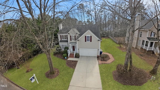 view of front of house featuring a garage and a front lawn