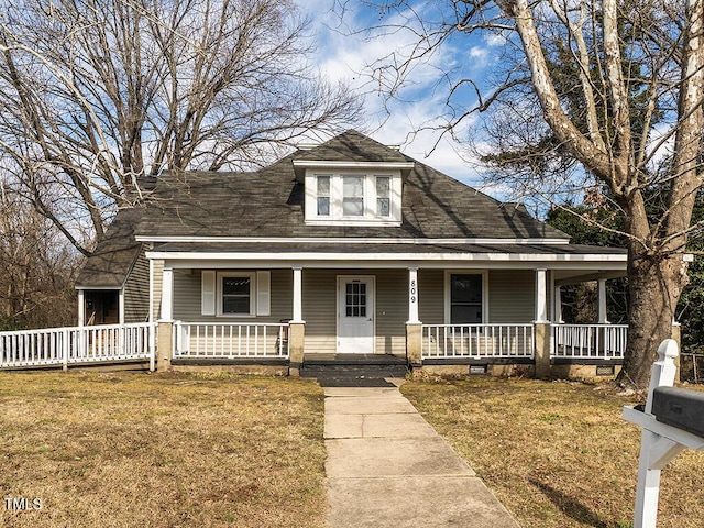 view of front of house featuring covered porch and a front yard