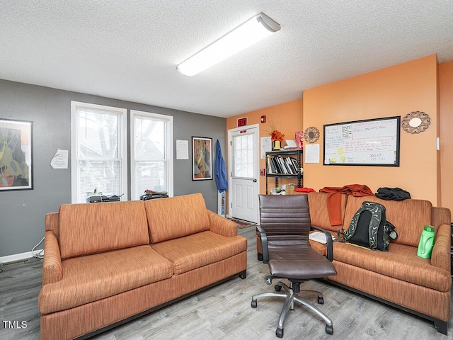 living room with wood-type flooring and a textured ceiling