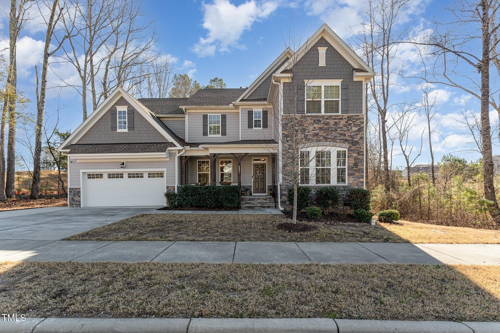 craftsman-style home with a garage and a porch