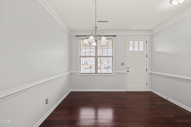 interior space with ornamental molding, an inviting chandelier, and dark hardwood / wood-style flooring