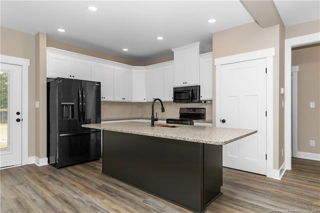 kitchen with black appliances, a sink, white cabinets, dark wood finished floors, and recessed lighting