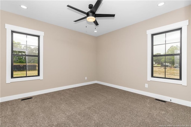 carpeted spare room with plenty of natural light, baseboards, a ceiling fan, and recessed lighting