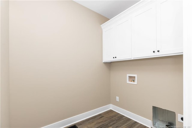 washroom featuring cabinet space, hookup for a washing machine, baseboards, and dark wood finished floors