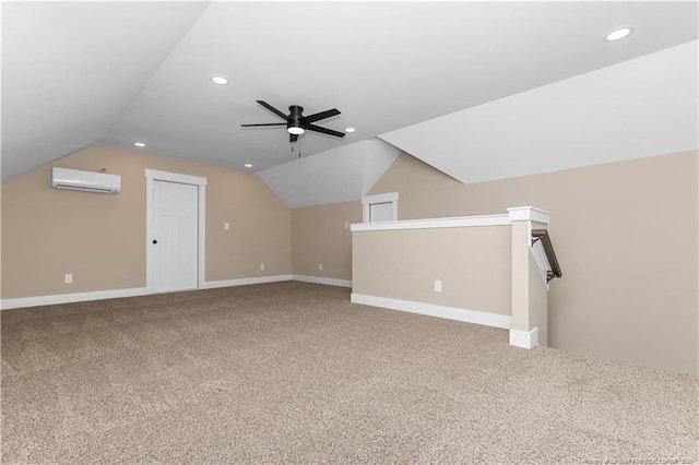 additional living space featuring a wall unit AC, carpet, recessed lighting, lofted ceiling, and baseboards