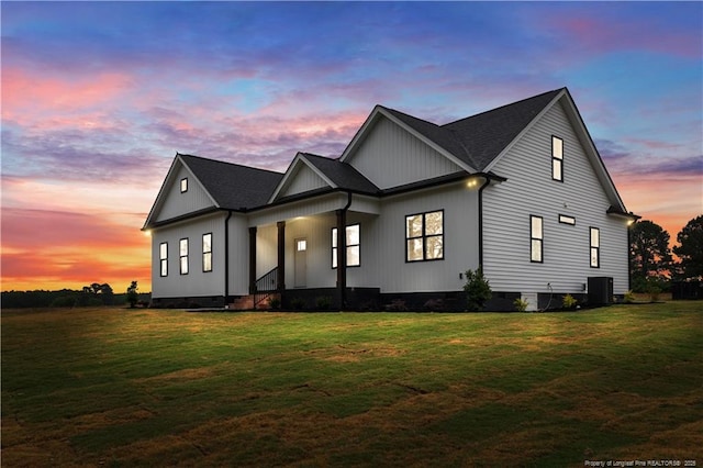 modern farmhouse style home with crawl space, a front lawn, central AC unit, a porch, and board and batten siding