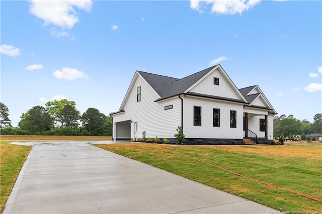 view of home's exterior with crawl space, concrete driveway, a yard, and a garage