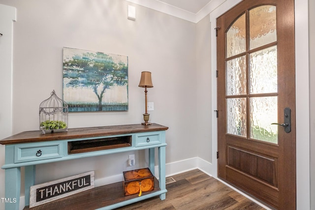 entryway with crown molding and dark wood-type flooring