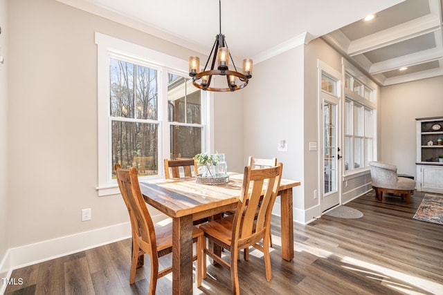 dining area featuring a notable chandelier, dark wood-type flooring, and ornamental molding