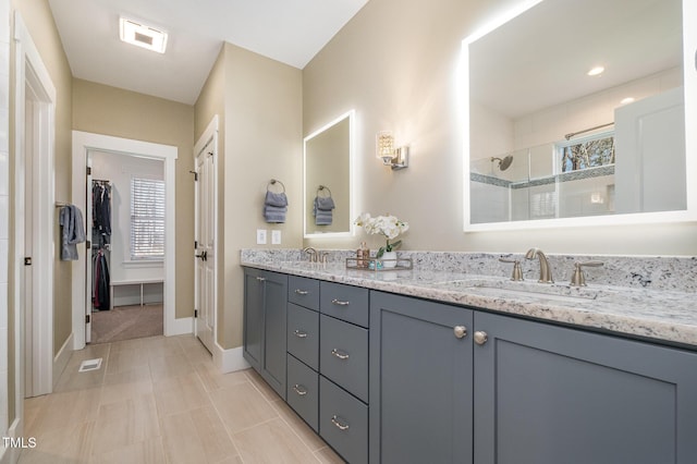 bathroom featuring vanity and an enclosed shower