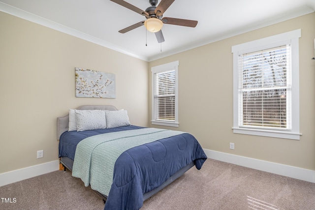 carpeted bedroom with multiple windows, ornamental molding, and ceiling fan