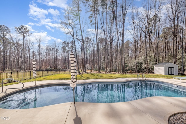 view of pool with a storage shed and a yard