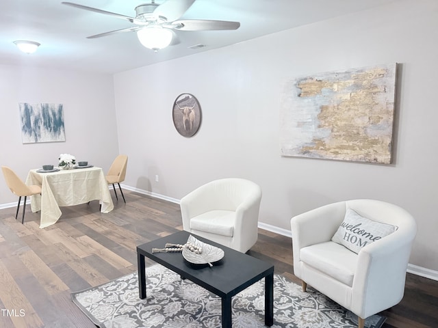 sitting room with hardwood / wood-style floors and ceiling fan