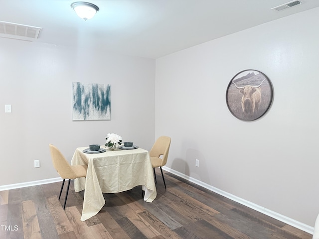 dining area with dark hardwood / wood-style flooring