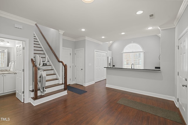 entryway featuring crown molding and dark hardwood / wood-style flooring