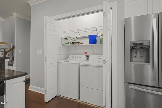 washroom with dark hardwood / wood-style flooring, crown molding, and washer and dryer