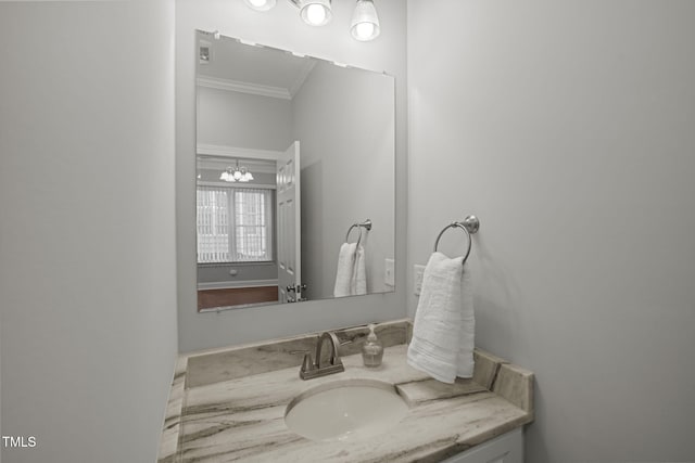 bathroom featuring vanity, a notable chandelier, and crown molding