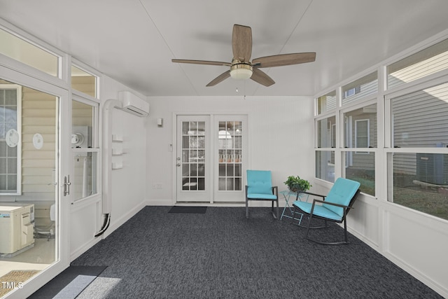 unfurnished sunroom featuring ceiling fan, an AC wall unit, a healthy amount of sunlight, and french doors