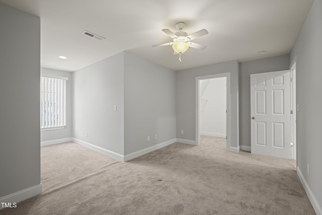 unfurnished room with light carpet and ceiling fan