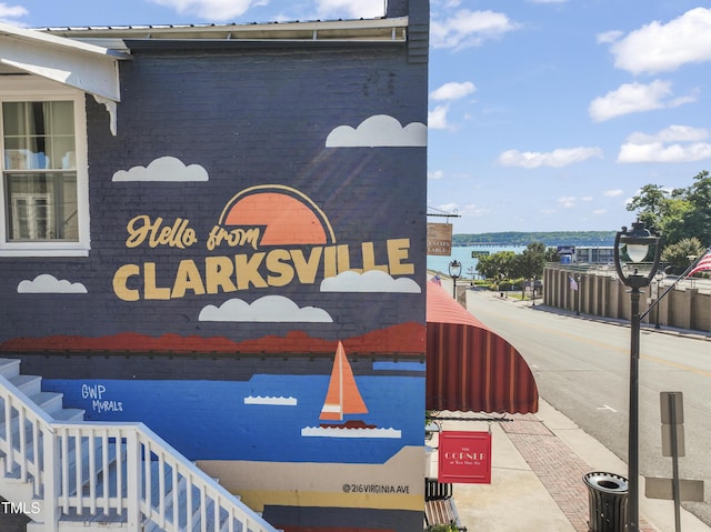 community / neighborhood sign featuring a water view