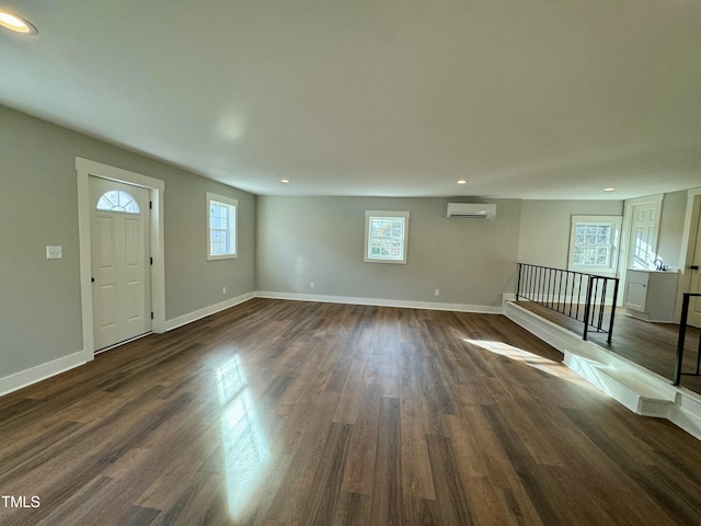 interior space featuring dark hardwood / wood-style flooring and an AC wall unit