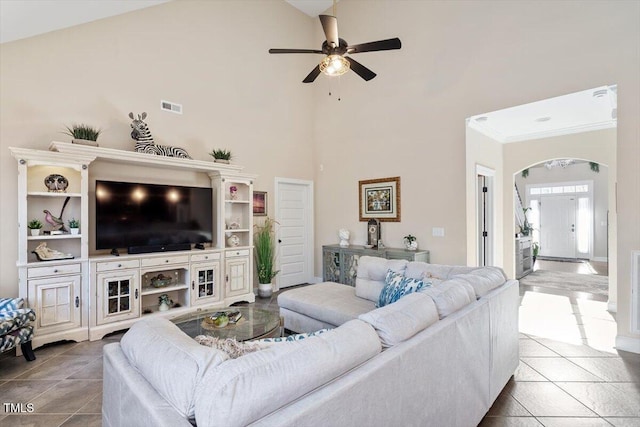 tiled living room featuring crown molding, ceiling fan, and high vaulted ceiling