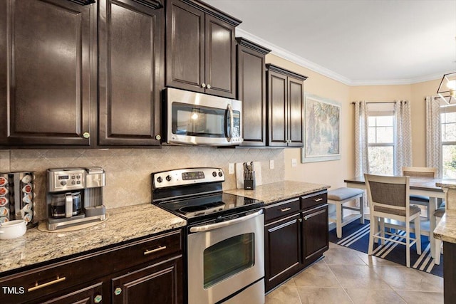 kitchen with ornamental molding, appliances with stainless steel finishes, dark brown cabinets, and decorative backsplash