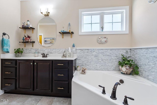 bathroom featuring vanity and a washtub