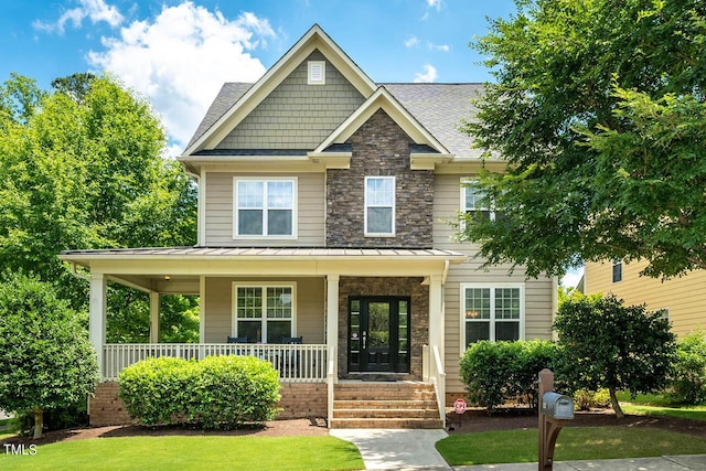 craftsman-style home featuring a porch and french doors