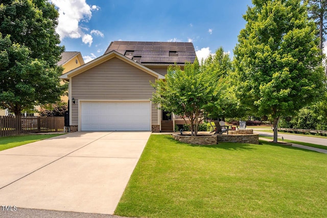 view of front of house with a garage, a front yard, and solar panels