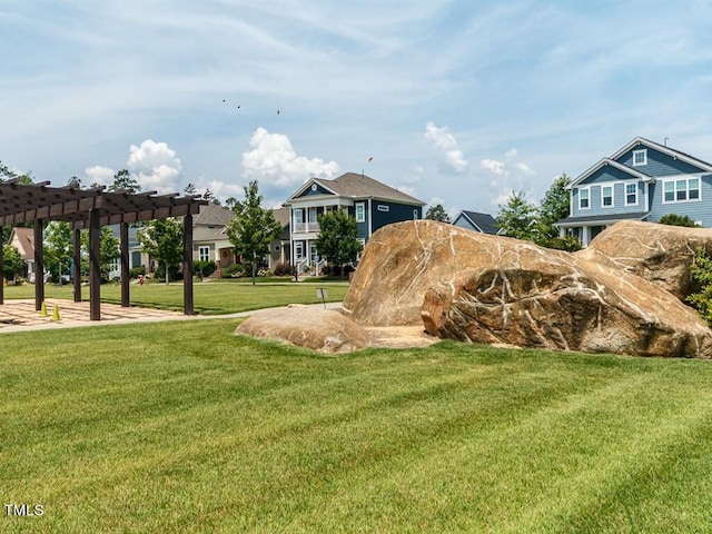 view of home's community with a yard