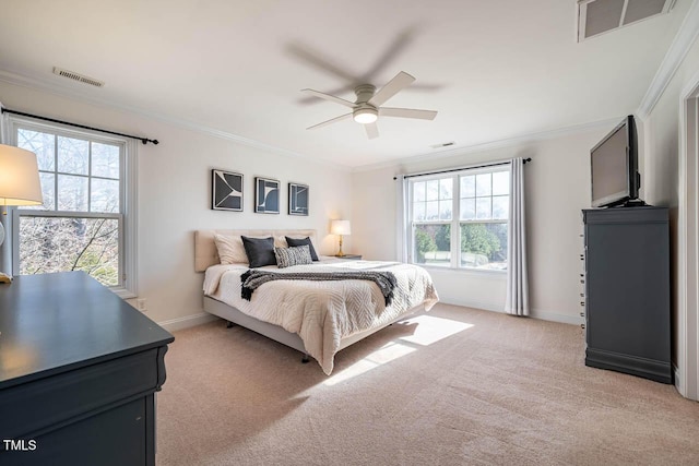 bedroom with ornamental molding, light carpet, and multiple windows