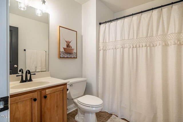 bathroom featuring vanity, tile patterned floors, and toilet