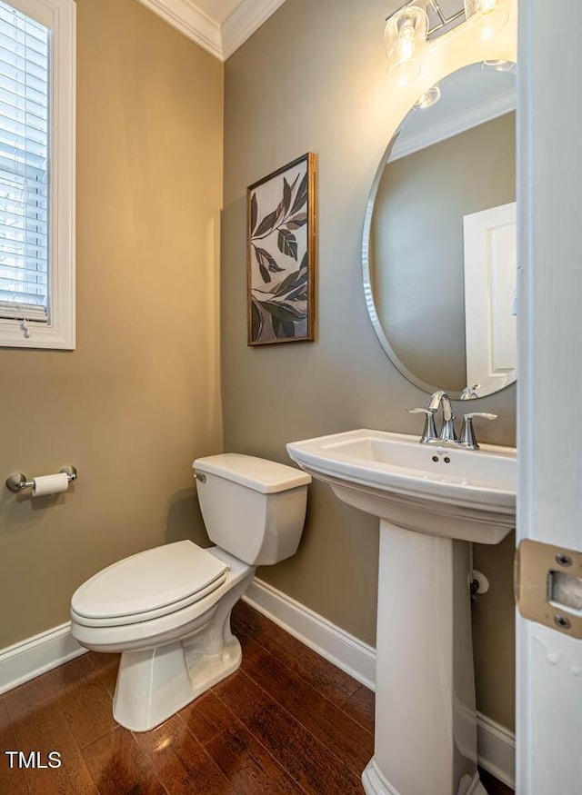 bathroom featuring ornamental molding, toilet, and hardwood / wood-style floors