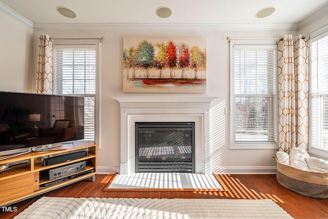 living room featuring crown molding, dark hardwood / wood-style flooring, and a wealth of natural light