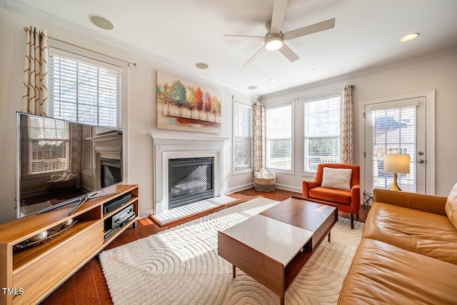 living room featuring hardwood / wood-style flooring, a wealth of natural light, and ornamental molding