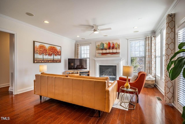 living room with crown molding, dark hardwood / wood-style floors, and a wealth of natural light