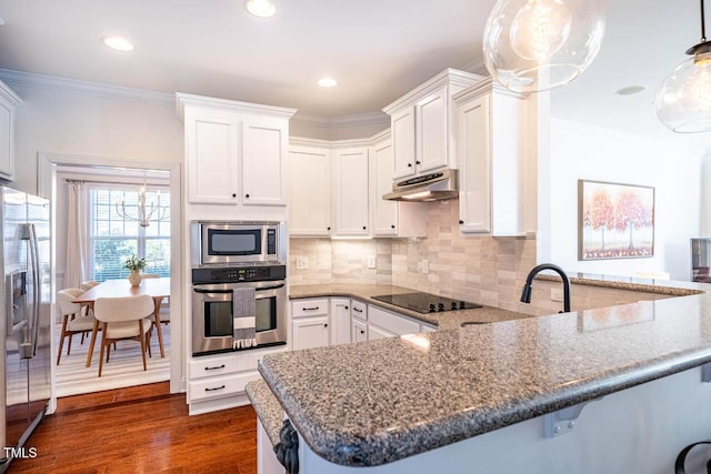 kitchen with white cabinetry, dark hardwood / wood-style flooring, kitchen peninsula, pendant lighting, and stainless steel appliances