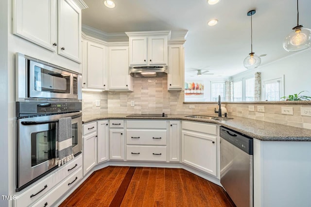 kitchen featuring pendant lighting, white cabinetry, sink, light stone counters, and stainless steel appliances