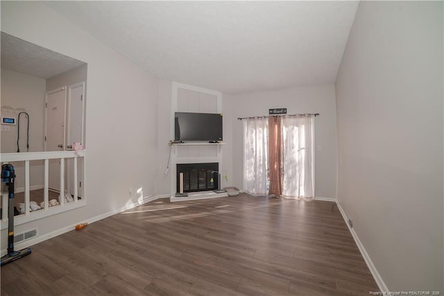 unfurnished living room with hardwood / wood-style floors and a fireplace