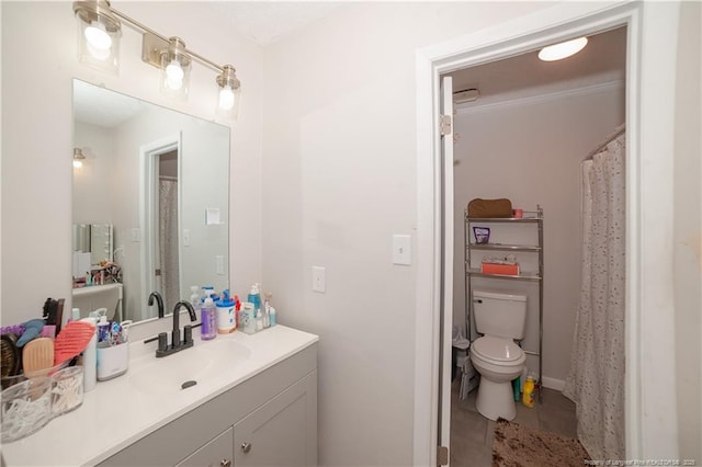 bathroom with vanity, tile patterned floors, and toilet