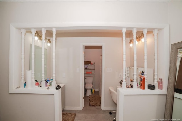 bathroom featuring tile patterned flooring and toilet