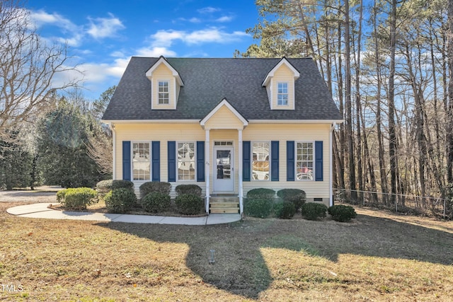 cape cod home with a front lawn