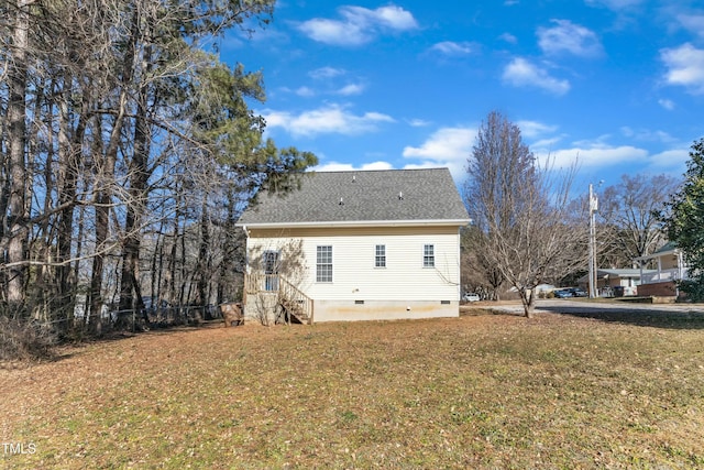 back of property with a lawn