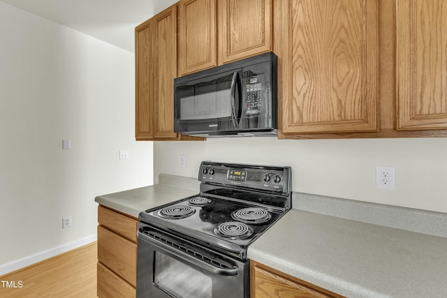 kitchen featuring black appliances and light wood-type flooring