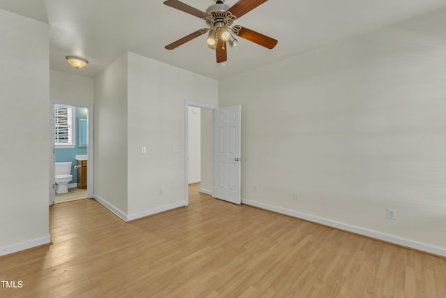 interior space with ensuite bath and light hardwood / wood-style flooring