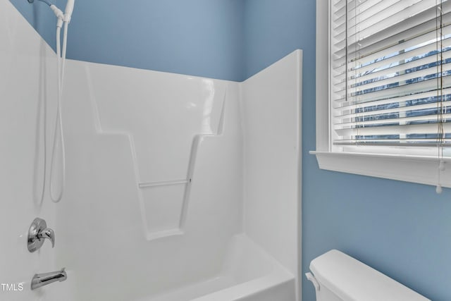 bathroom featuring shower / bathtub combination and toilet