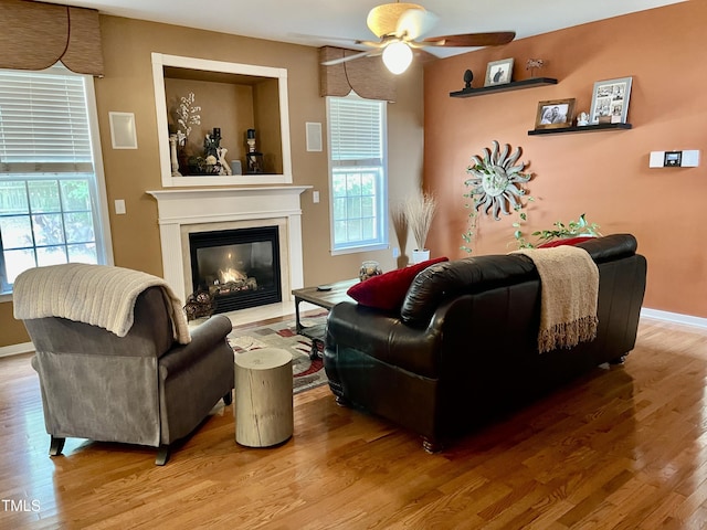 living room featuring a healthy amount of sunlight, hardwood / wood-style floors, and ceiling fan